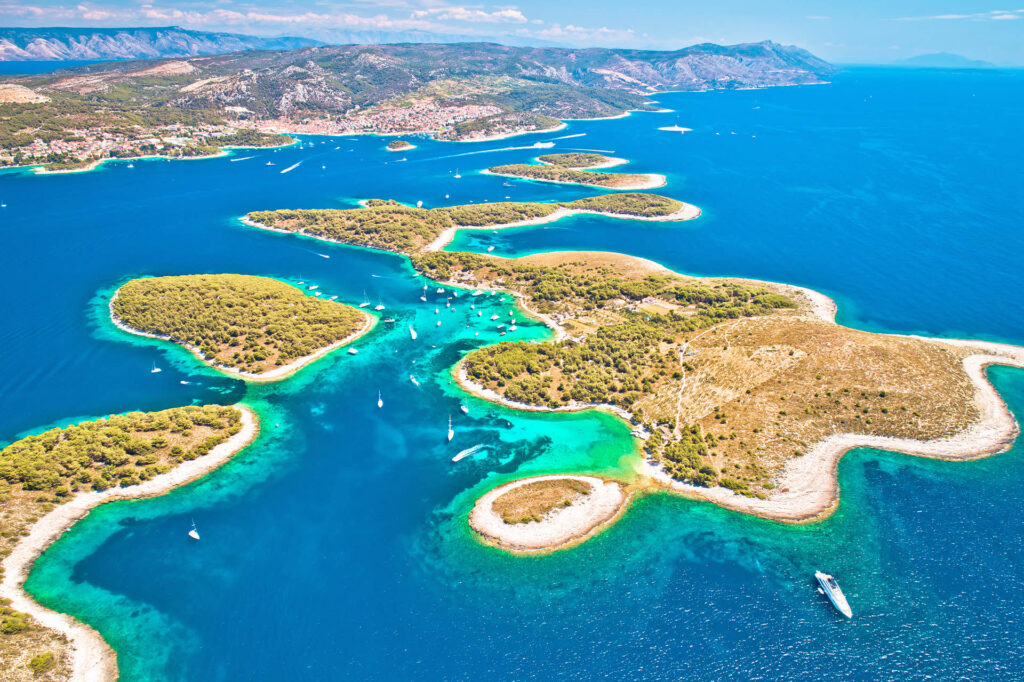 Above Hvar Island: A breathtaking aerial perspective showcasing the blend of coastal beauty, historic charm, and vibrant landscapes.