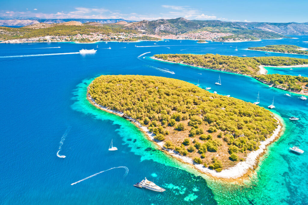 The Hvar island captures the historic town's red-roofed architecture, nestled against the coastline, with azure waters and lush greenery surrounding the Pakleni archipelago. A captivating blend of history, nature, and coastal beauty in the heart of Croatia.