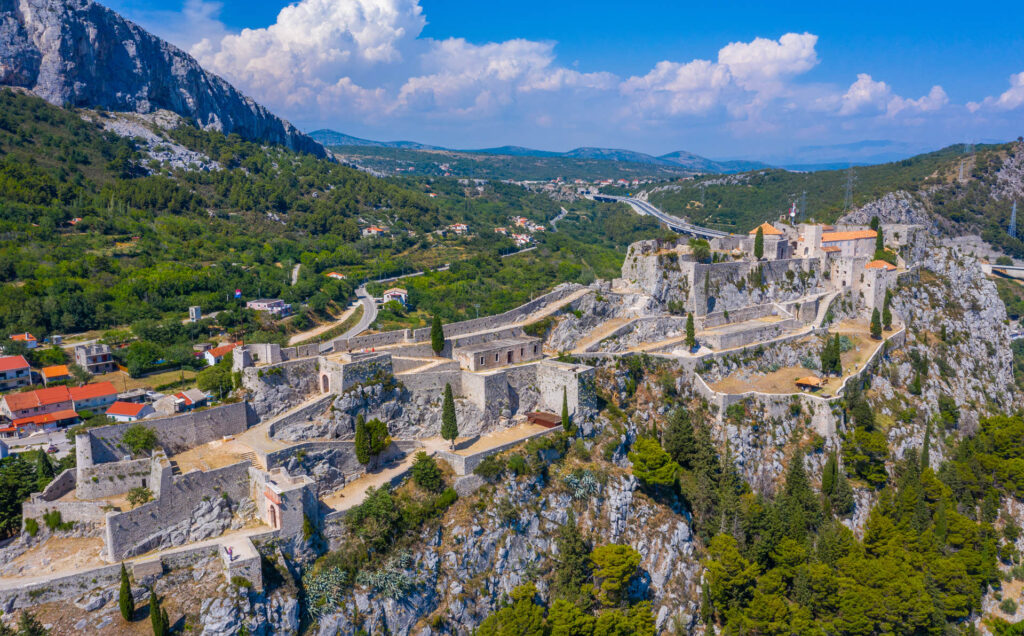 Klis Fortress is located southeast from Trogir. Majestic medieval stronghold with panoramic views of the Dalmatian coast, a historical marvel and popular tourist attraction in Croatia.
