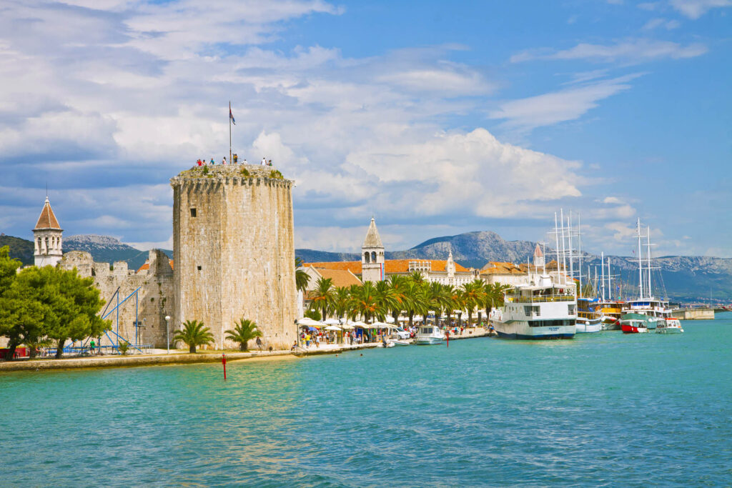 Trogir's Coastal Beauty: A picturesque view from the sea showcasing the old town and fortress, harmoniously blending history and seaside allure.
